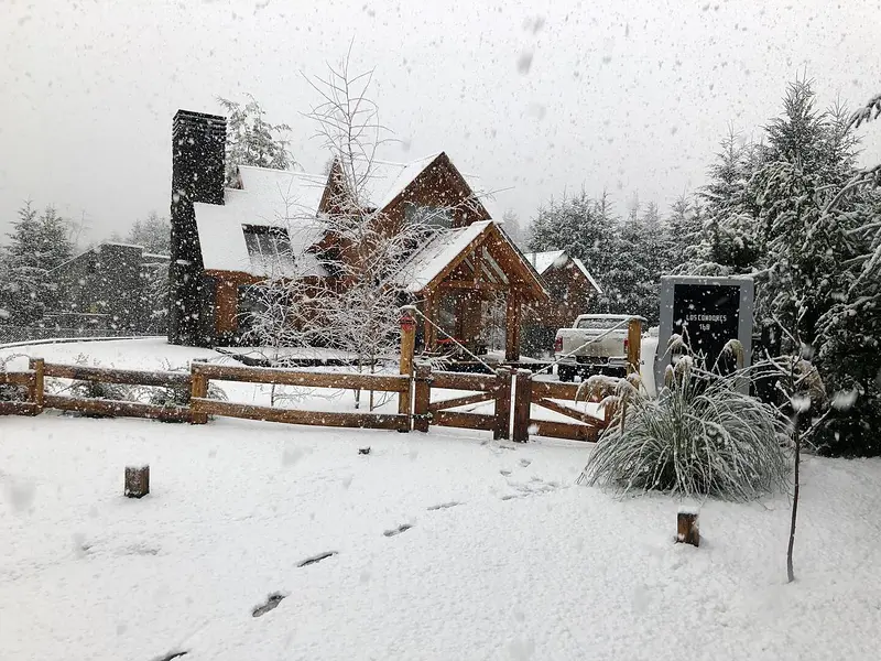 The cabins in the snow and the stone chimney